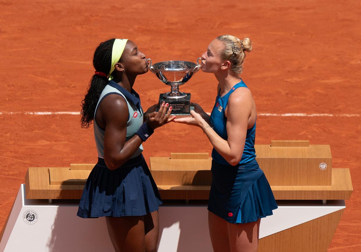 Jun 9, 2024; Paris, France; Coco Gauff of the United States and Katerina Siniakova of the Czech Republic kiss the trophy after winning the women’s final against Sara Errani of Italy and Jasmine Paolini of Italy on day 15 of Roland Garros at Stade Roland Garros. Mandatory Credit: Susan Mullane-USA TODAY Sports