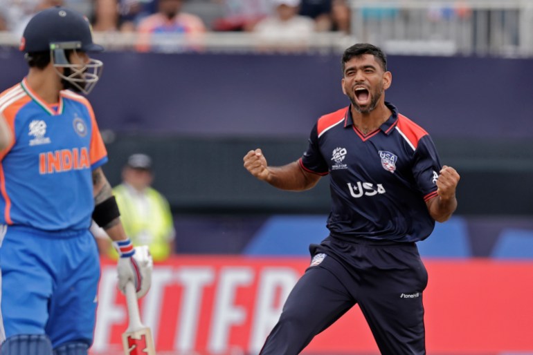 United States' Saurabh Nethralvakar, right, celebrates the dismissal of India's Virat Kohli, left, during the ICC Men's T20 World Cup cricket match between United States and India at the Nassau County International Cricket Stadium in Westbury, New York, Wednesday, June 12, 2024. (AP Photo/Adam Hunger)